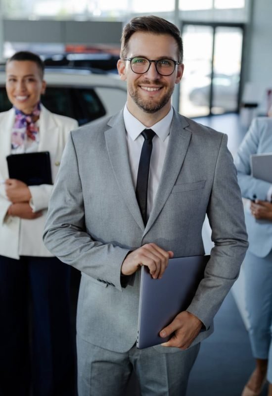 salesteam-in-dealership-three-beautiful-consultants-or-managers-in-elegant-suit-looking-on-camera-.jpg